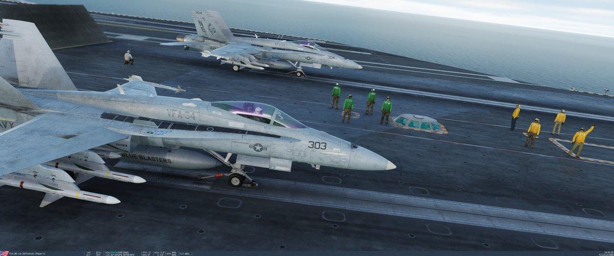 Aircraft and deck crew on the carrier flight deck