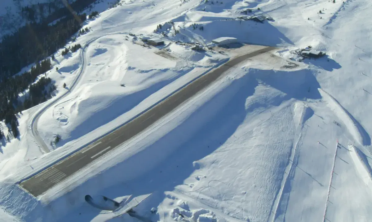Courchevel altiport in the French Alps — the dramatically sloping runway carved into the mountainside with snow on all sides