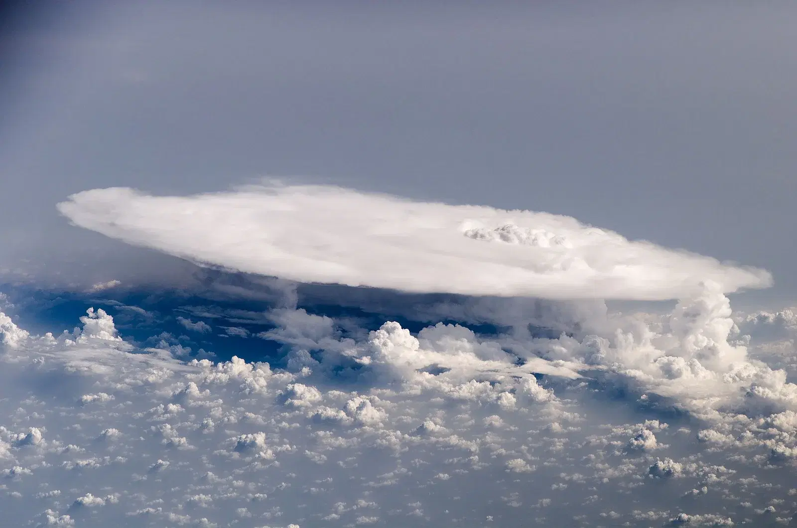Cumulonimbus storm cell with an overshooting top photographed from the International Space Station — the sharp convective weather that live weather notoriously flattens into generic cloud