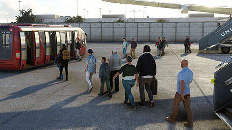 Passengers walking to the aircraft via airstairs at a remote stand