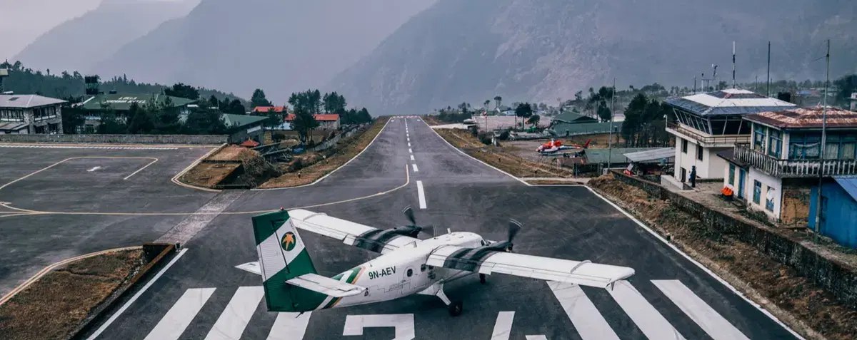 Lukla airport in Nepal — the short, upsloped runway with mountains rising on all sides, one of the most demanding visual approaches in the world