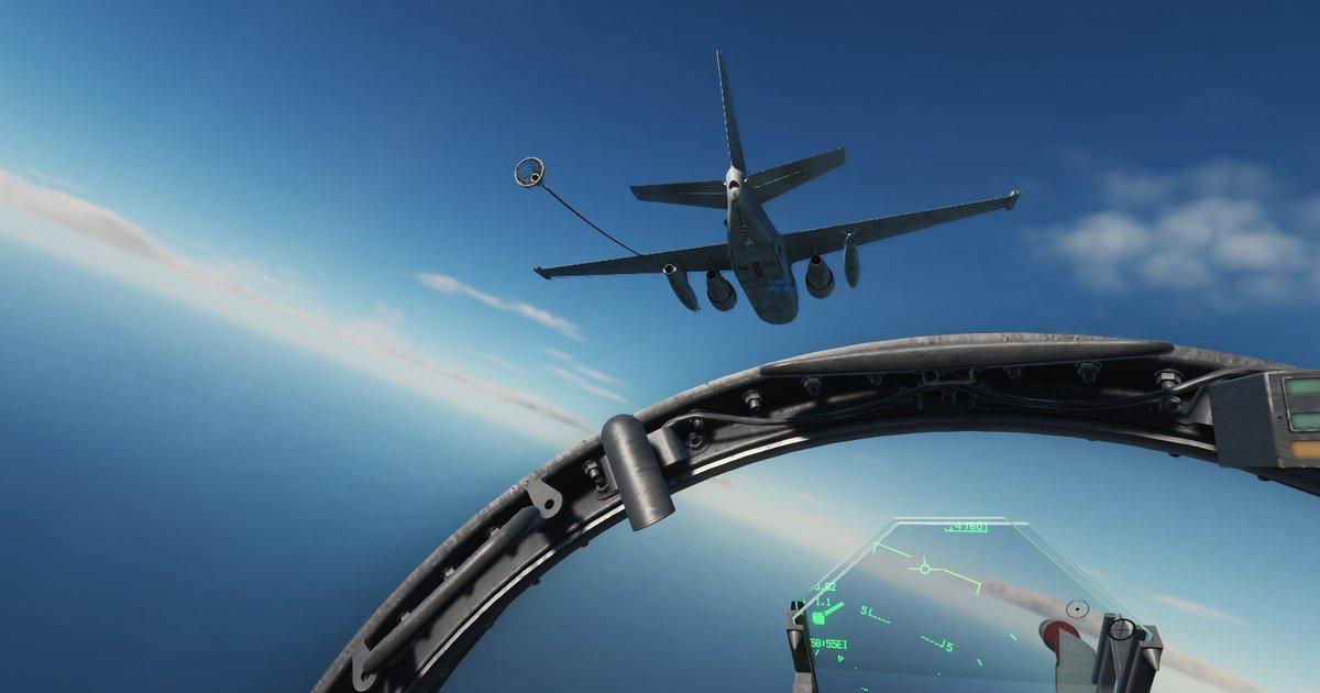 Fighter jet cockpit view looking up at a KC-135 tanker aircraft with refueling boom extended against a blue sky