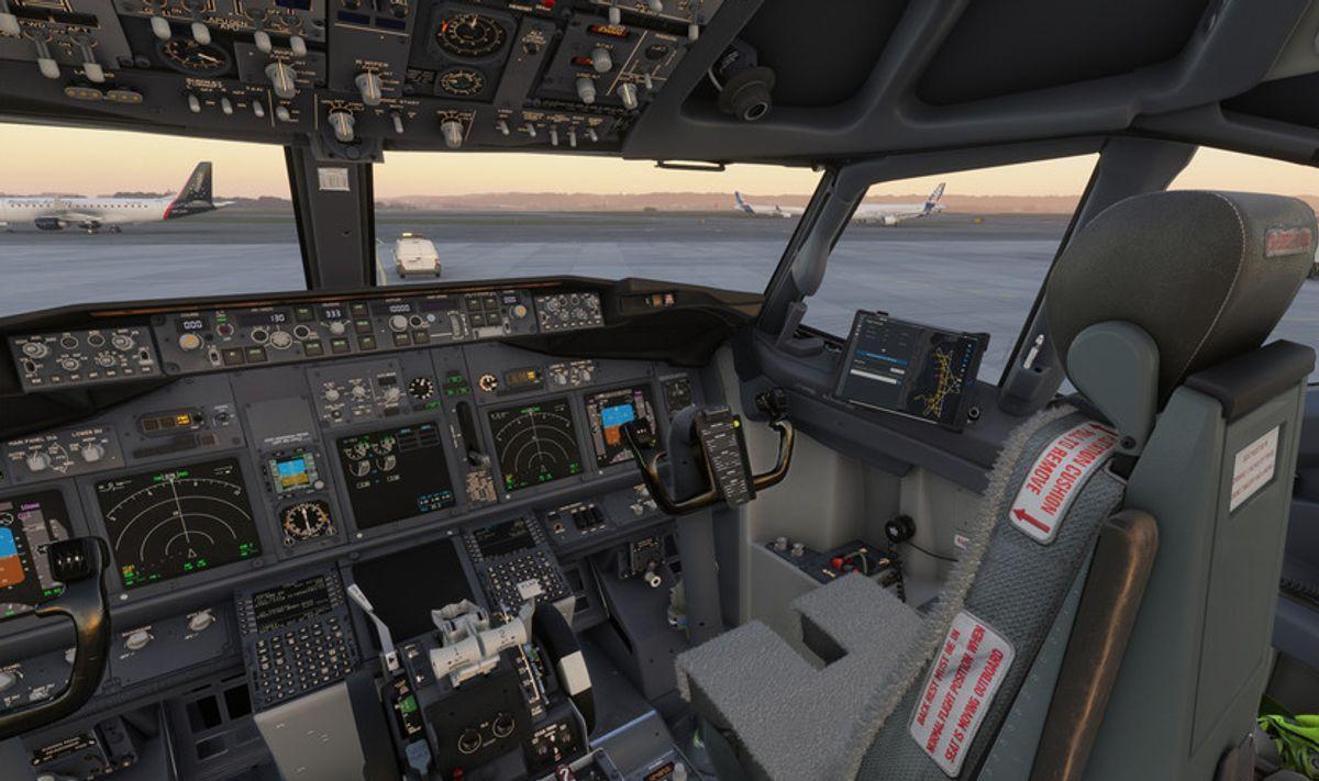 PMDG 737-800 cockpit in cold and dark state, unpowered displays and overhead panel visible