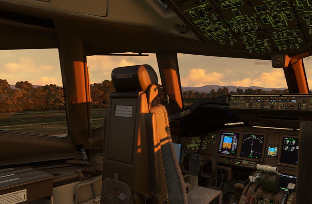 PMDG 777-300ER cockpit at golden hour before startup, captain's seat view with displays off